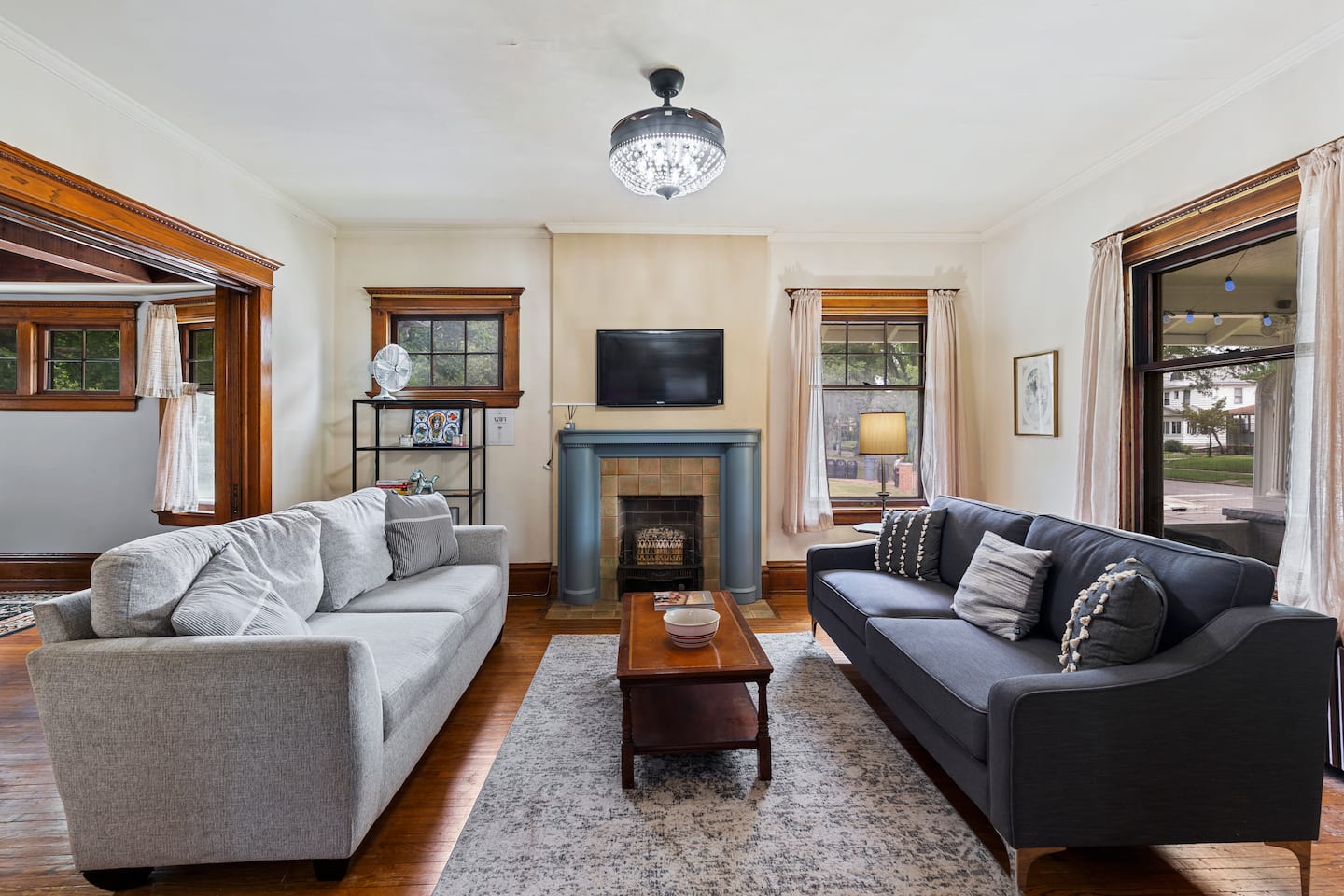Living room with original dark woodwork and fireplace