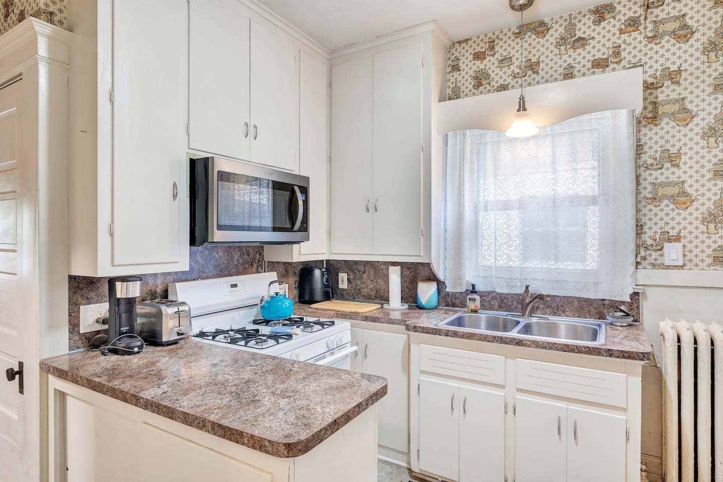 Bright full kitchen with vintage patterned walls