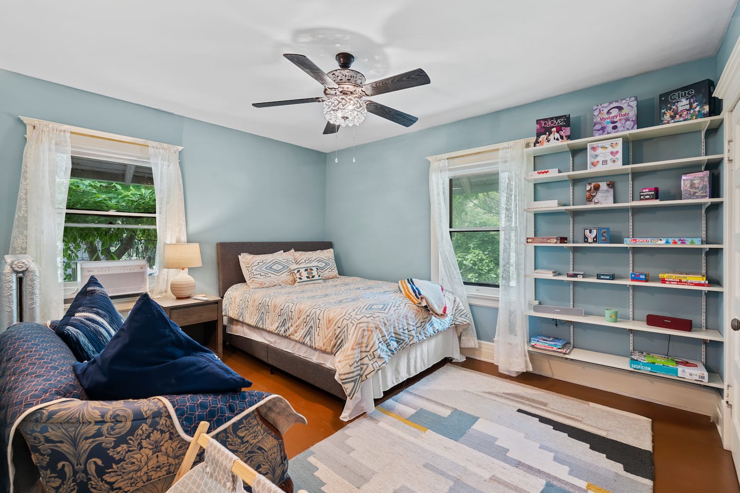 Airy bedroom with two beds and built-in shelving