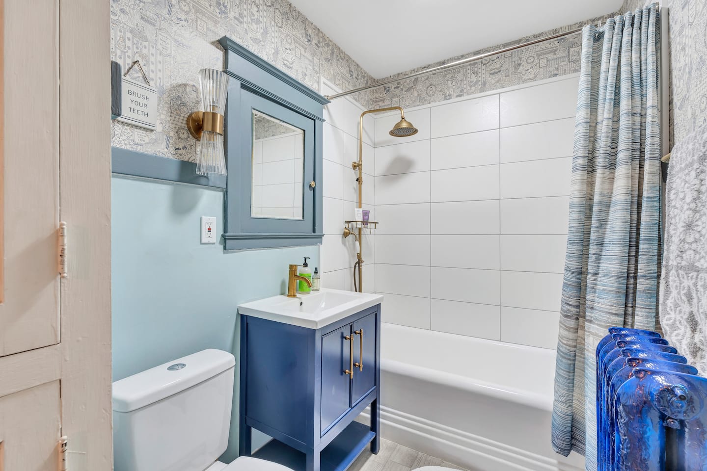 The home's upstairs full bathroom with tub and shower