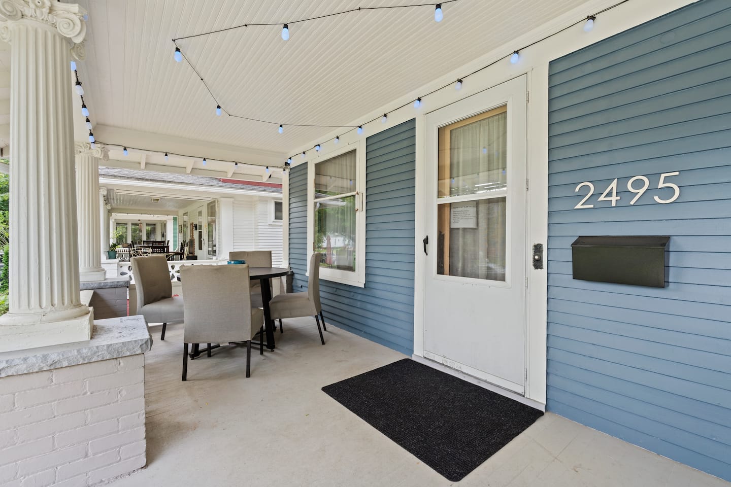 Covered front porch beside the 2495 house number